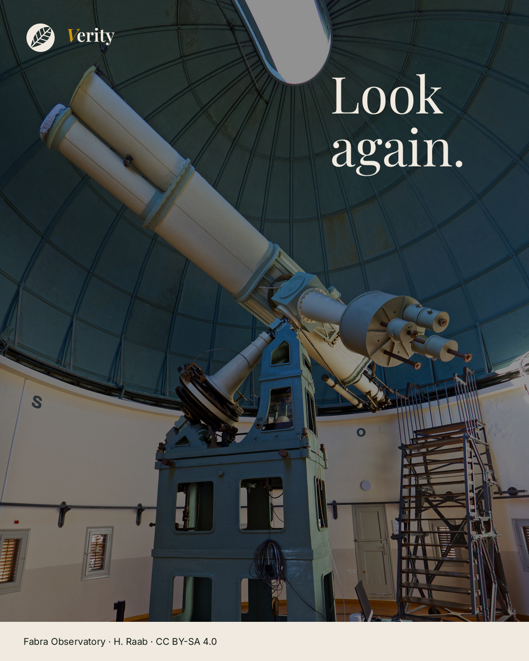The double refractor at Fabra Observatory points diagonally across its dome. The words Look again sit beside the instrument.